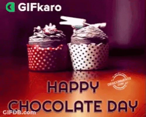 Two Cupcakes Are Sitting On A Table With The Words Happy Chocolate Day Written Above Them . GIF