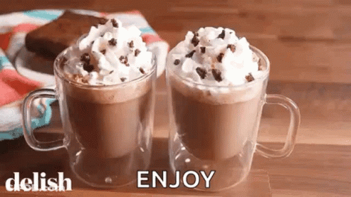 Two Cups Of Hot Chocolate With Whipped Cream And Chocolate Chips GIF
