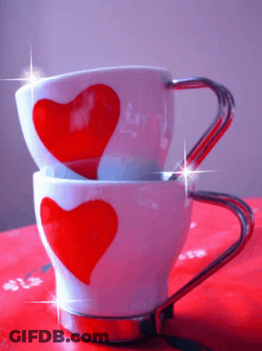 Two Cups With Red Hearts Stacked On Table GIF
