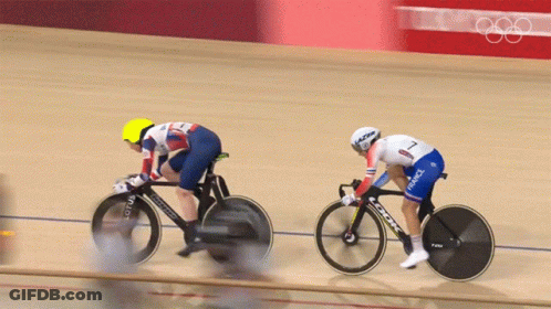 Two Cyclists Are Racing On A Track And One Is Wearing A France Uniform GIF