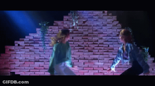 Two Dancers Dancing In Front Of Brick Wall GIF