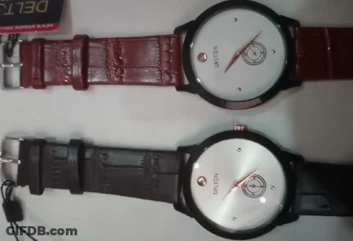 Two Delta Watches Are Sitting On A White Surface GIF