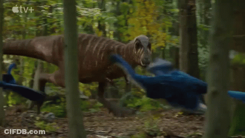 Two Dinosaurs Are Fighting In The Woods With An Apple Tv Logo In The Background . GIF