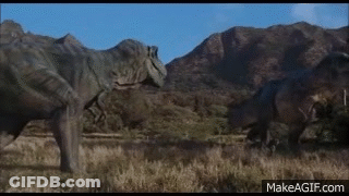 Two Dinosaurs Are Standing Next To Each Other In A Field In Front Of Mountains . GIF