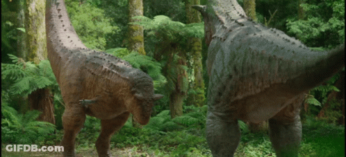 Two Dinosaurs Standing In Forest GIF