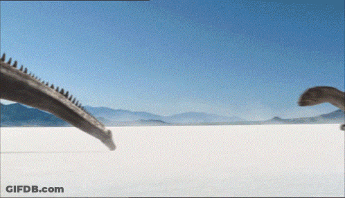 Two Dinosaurs Walking Across Desert GIF