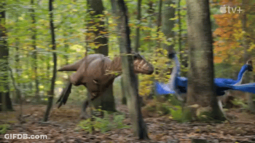 Two Dinosaurs Walking Through Forest With Apple TV+ Logo GIF