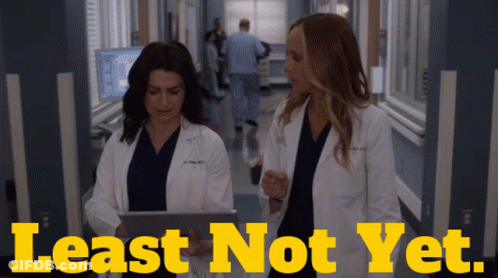 Two Doctors In A Hospital Hallway With The Words Least Not Yet On The Bottom GIF