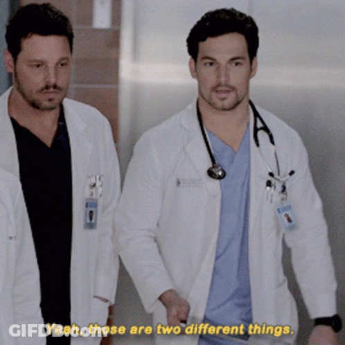 Two Doctors Walking Down Hallway Saying Yeah Those Are Two Different Things GIF