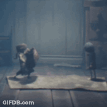 Two Dolls Standing On Rug In Dark Room GIF
