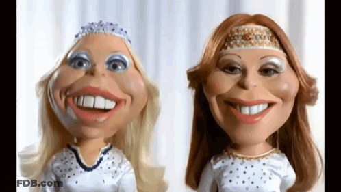 Two Dolls With Big Smiles On Their Faces Are Standing Next To Each Other On A White Background . GIF