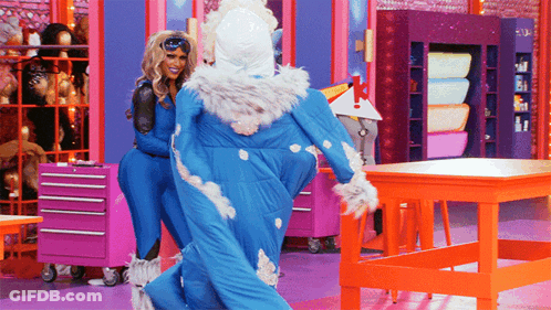 Two Drag Queens Standing Next To Each Other GIF