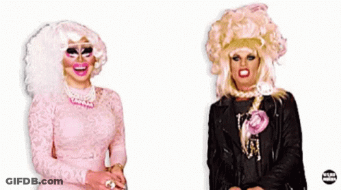Two Drag Queens Are Standing Next To Each Other With The Word Doctor Behind Them GIF