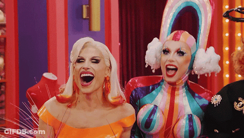 Two Drag Queens Are Standing Next To Each Other With Their Mouth Open GIF