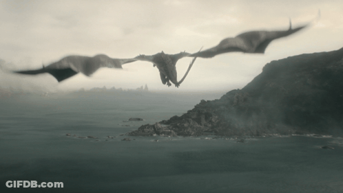 Two Dragons Are Flying Over A Body Of Water With Mountains In The Background GIF