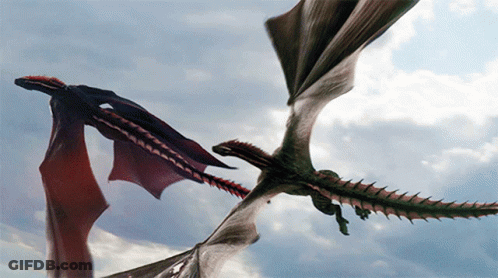 Two Dragons Flying In The Sky With Their Wings Outstretched GIF