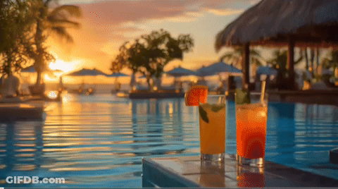 Two Drinks On Table Near Pool At Sunset GIF
