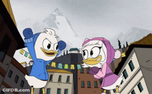 Two Ducks Standing In Front Of Buildings GIF