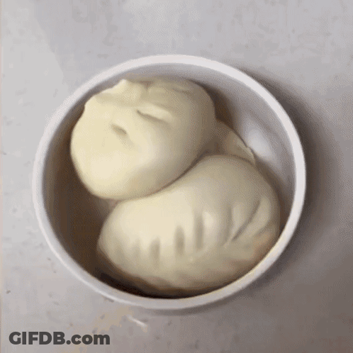 Two Dumplings In A Bowl That Looks Like A Person 'S Face GIF
