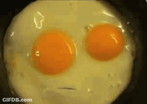 Two Eggs In Pan Looking Like Face GIF