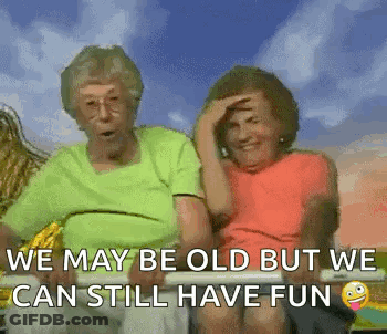 Two Elderly Women Are Sitting Next To Each Other On A Bench With The Caption `` We May Be Old But We Can Still Have Fun GIF