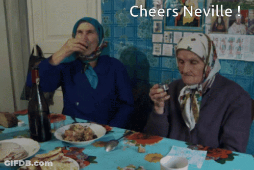 Two Elderly Women Sit At A Table With The Words Cheers Neville GIF