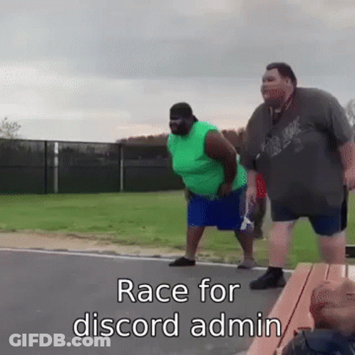Two Fat Men Standing Together On Roadside GIF