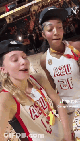 Two Female Basketball Players Posing On Court GIF