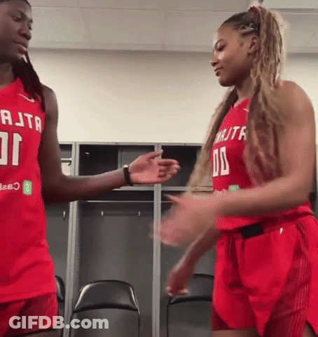 Two Female Basketball Players Shaking Hands In Red RTA Jerseys GIF