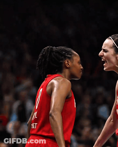 Two Female Basketball Players Wearing Red Uniforms With The Number 8 On The Back GIF