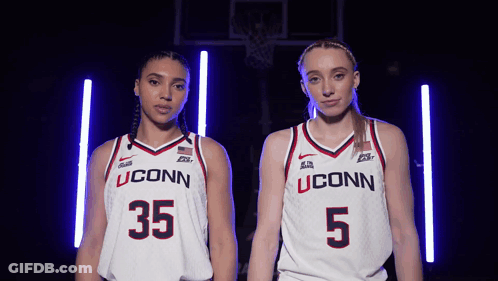 Two Female Basketball Players Wearing Uconn Uniforms Stand Next To Each Other GIF