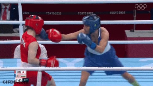 Two Female Boxers Are Fighting In A Boxing Ring At The Olympics . GIF