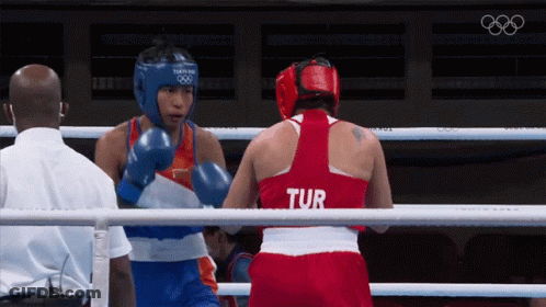 Two Female Boxers In A Ring One Of Whom Is Wearing A Tur Shirt GIF