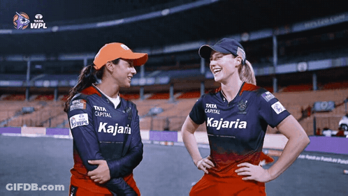 Two Female Cricket Players Wearing Shirts That Say Kajaria On Them GIF