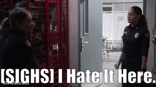 Two Female Firefighters Standing Next To Each Other With The Words ' Sighs I Hate It Here ' Above Them GIF