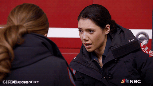 Two Female Firefighters Talking In Front Of Fire Truck With NBC Logo GIF