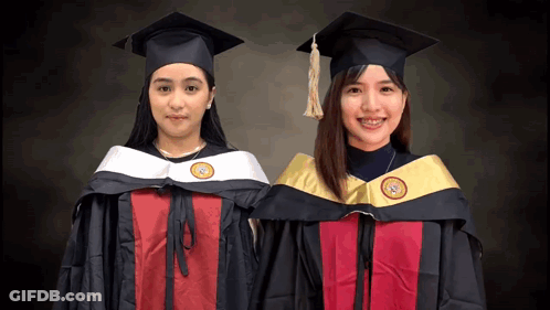 Two Female Graduates Standing GIF