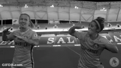 Two Female Soccer Players Dancing In Stadium GIF