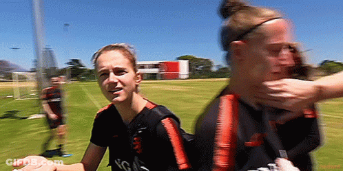 Two Female Soccer Players Holding Face GIF