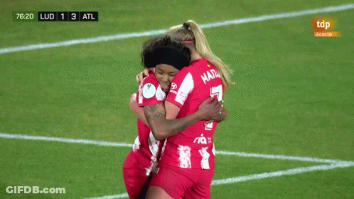 Two Female Soccer Players Hugging On Field With TDP Ad GIF