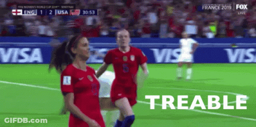 Two Female Soccer Players On A Field With The Word Treable In The Corner GIF
