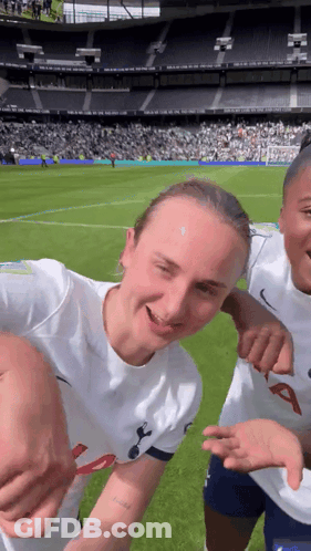 Two Female Soccer Players Pose GIF