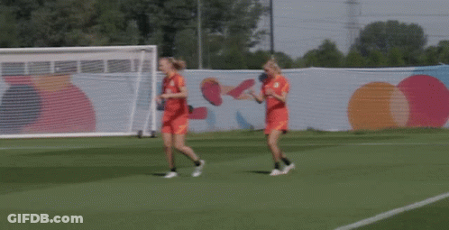 Two Female Soccer Players Running On A Field GIF