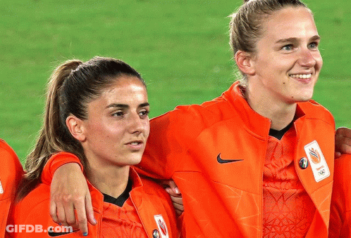 Two Female Soccer Players Wearing Orange Nike Jackets GIF