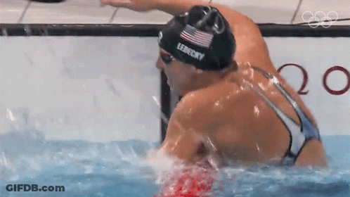 Two Female Swimmers Are Swimming In A Pool And One Of Them Is Wearing A Lefferts Swim Cap GIF