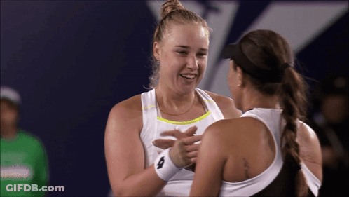 Two Female Tennis Players Are Hugging And One Has A Tattoo On Her Back That Says ' I Love You ' GIF