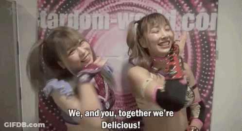 Two Female Wrestlers Are Posing For A Picture In Front Of A Wall . GIF