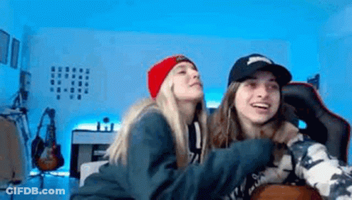 Two Female Wrestlers On Stage With Kai On Wall GIF