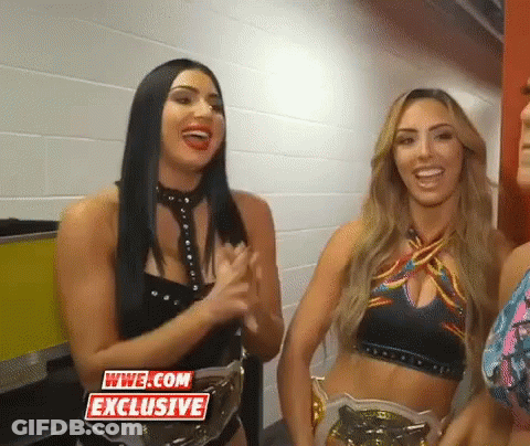 Two Female Wrestlers Smiling Next To Each Other GIF