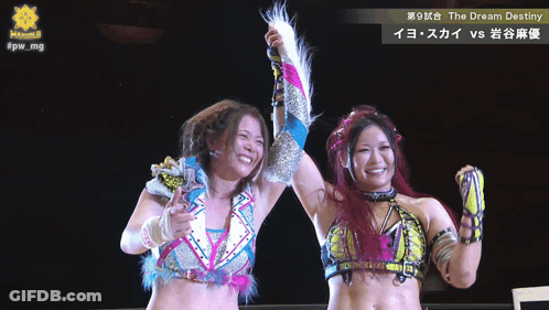 Two Female Wrestlers With The Dream Destiny Sign GIF